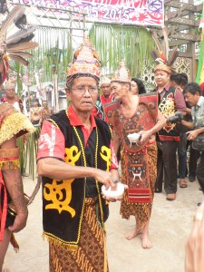 Dayak senior men sprinkling us with a little something to keep the evil spirits away