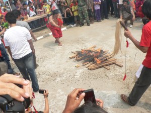 Note the skewers in his face. Just after this photo, he walked across the fire